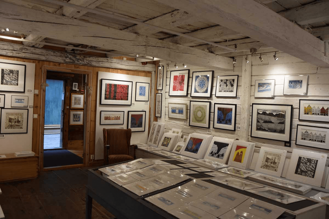 a view of the gallery with paintings on all the walls